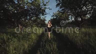 美丽的黑发女孩p在夏季<strong>优雅</strong>的衣服与绿色的树木。 森林里快乐<strong>优雅</strong>的女孩。